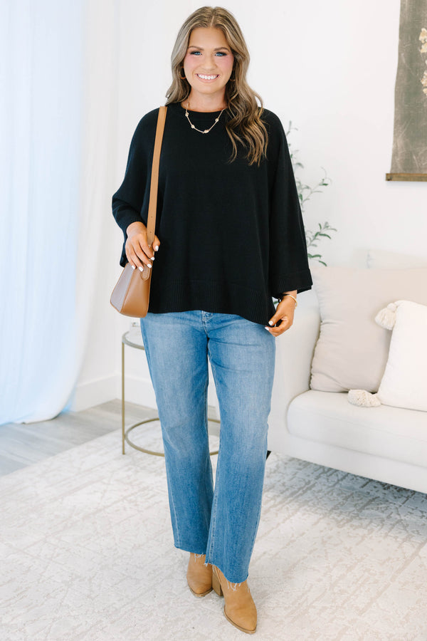 Plus Size black oversized knit sweater with a crew neckline and wide three-quarter length sleeves.