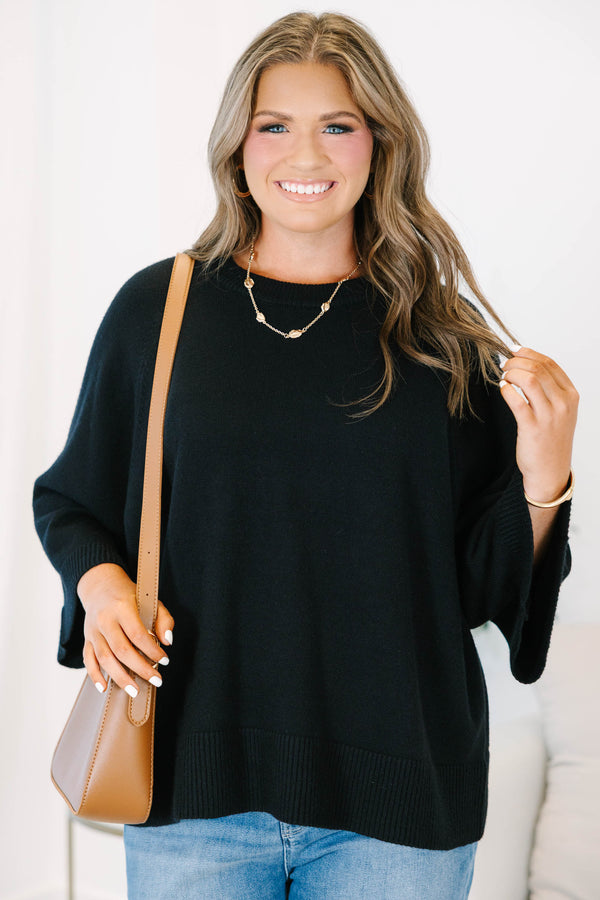 Plus Size black oversized knit sweater with a crew neckline and wide three-quarter length sleeves.