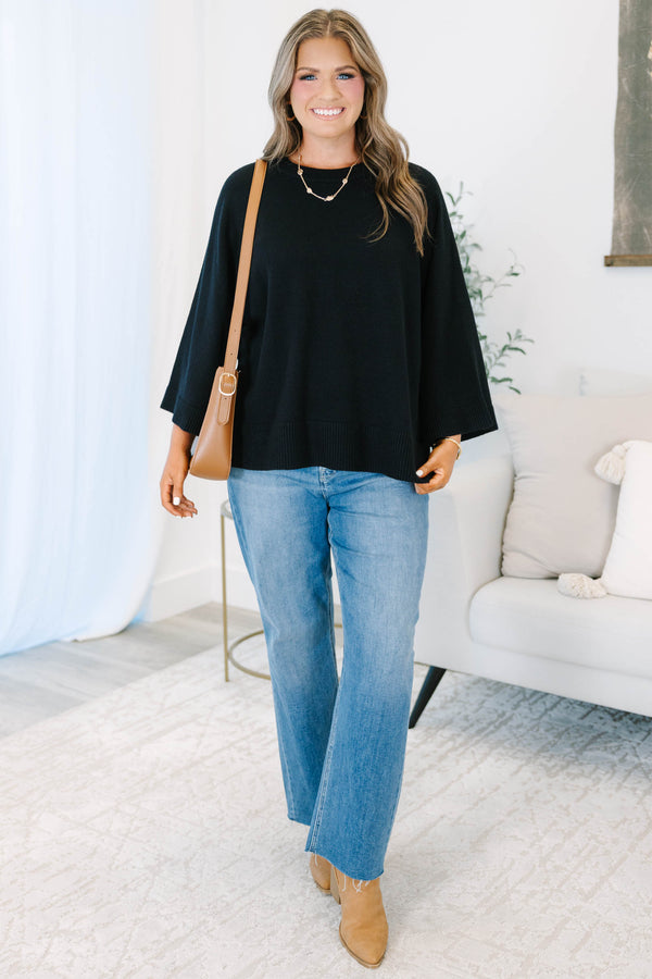 Plus Size black oversized knit sweater with a crew neckline and wide three-quarter length sleeves.