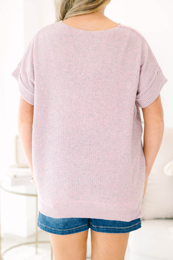 Plus size woman in a pink and gray marled knit short sleeve sweater with a relaxed, flowy fit.