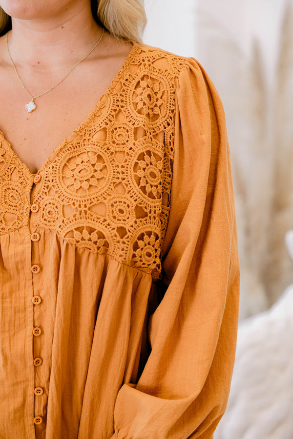 Chic Soul plus size clothing, long sleeve orange top with cuffed bubble sleeves with v neckline and textured geometric design along chest with button up detail down the front