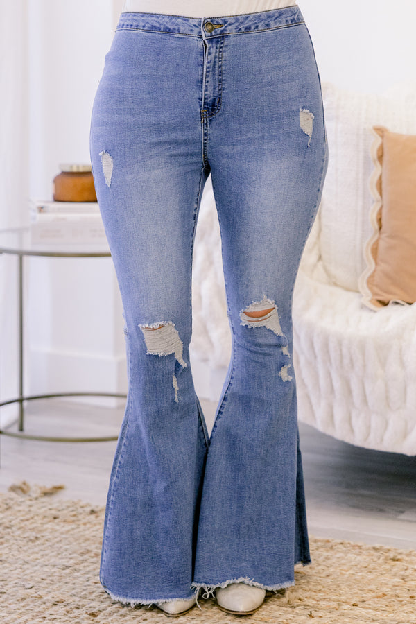 Chic Soul plus size medium wash distressed flare jeans featuring a high-waisted fit, ripped details, and frayed hem