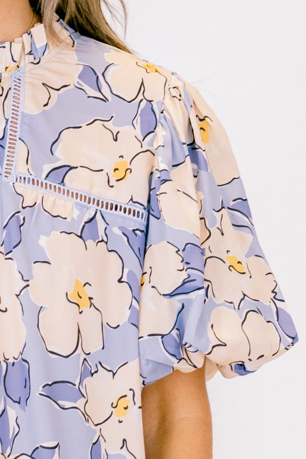 Chic Soul plus size clothing, short-puffed-sleeve periwinkle blue top with a ruffled mock neckline and a tan and blue floral watercolor pattern 