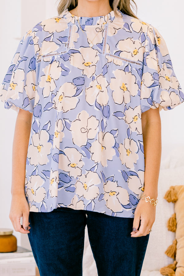 Chic Soul plus size clothing, short-puffed-sleeve periwinkle blue top with a ruffled mock neckline and a tan and blue floral watercolor pattern 
