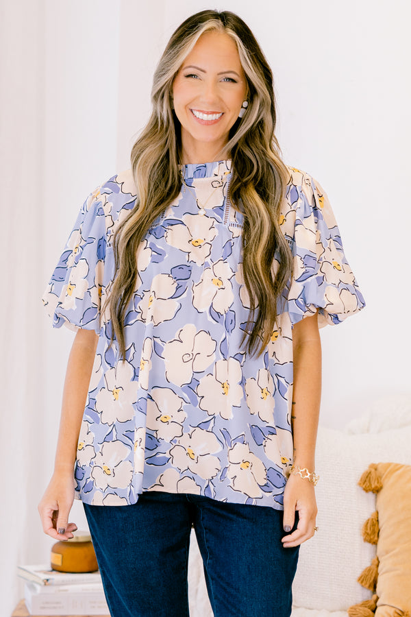 Chic Soul plus size clothing, short-puffed-sleeve periwinkle blue top with a ruffled mock neckline and a tan and blue floral watercolor pattern 