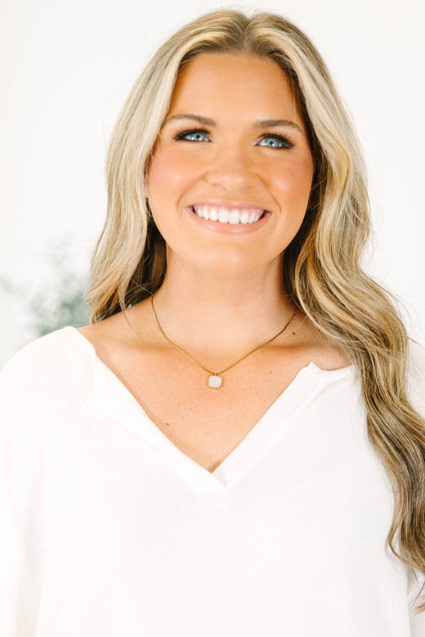 Gold box chain necklace featuring a square white mother of pearl pendant.
