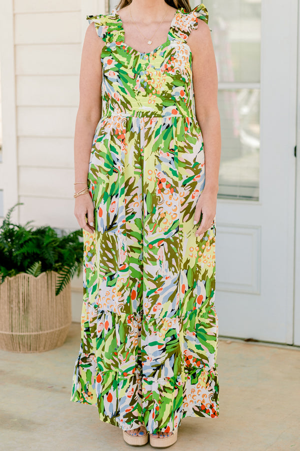 Chic Soul plus size clothing, sleeveless flutter strap green flowy wide-leg jumpsuit with a sweetheart neckline and a green multi-colored abstract tropical floral pattern 