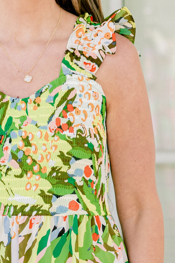 Chic Soul plus size clothing, sleeveless flutter strap green flowy wide-leg jumpsuit with a sweetheart neckline and a green multi-colored abstract tropical floral pattern 