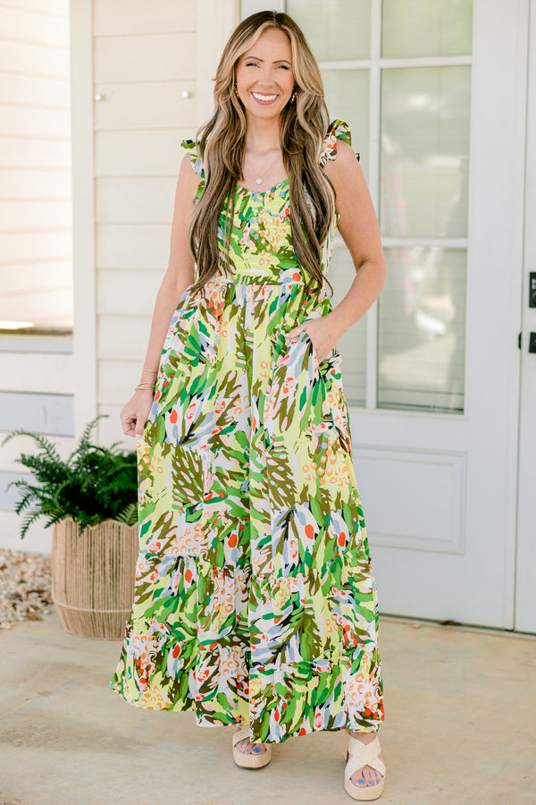 Chic Soul plus size clothing, sleeveless flutter strap green flowy wide-leg jumpsuit with a sweetheart neckline and a green multi-colored abstract tropical floral pattern 
