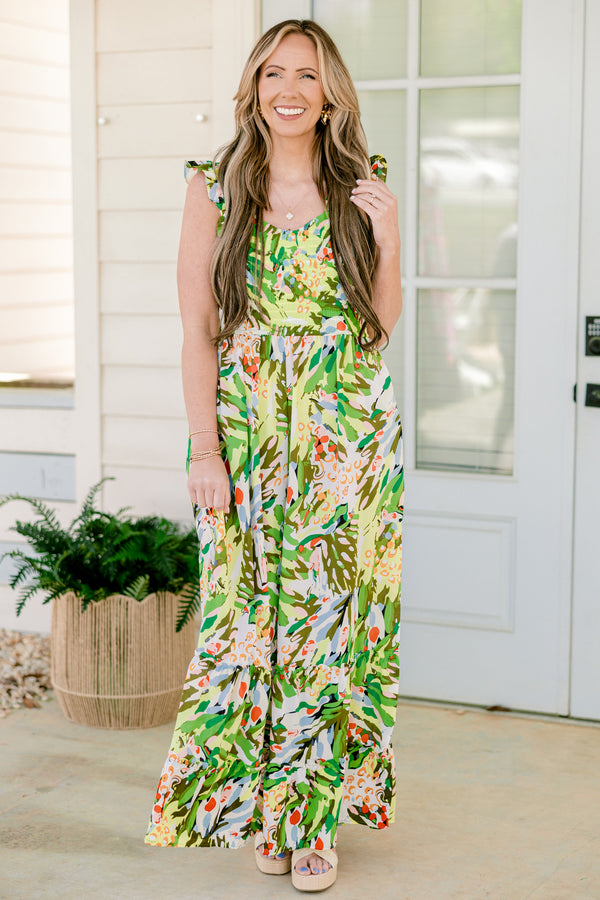 Chic Soul plus size clothing, sleeveless flutter strap green flowy wide-leg jumpsuit with a sweetheart neckline and a green multi-colored abstract tropical floral pattern 