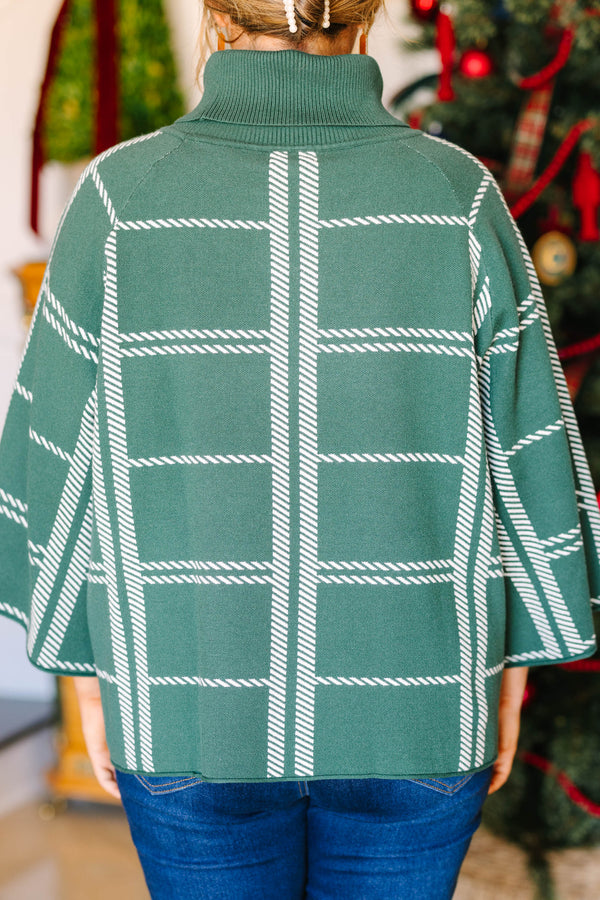 Plus size green turtleneck sweater with a white grid pattern and flowy, wide sleeves.