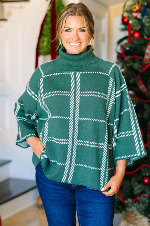 Plus size green turtleneck sweater with a white grid pattern and flowy, wide sleeves.