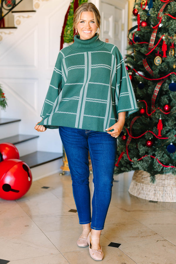 Plus size green turtleneck sweater with a white grid pattern and flowy, wide sleeves.