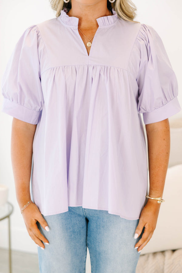 Plus Size lavender babydoll top with puff sleeves, a ruffled split neckline, and pleated bodice.