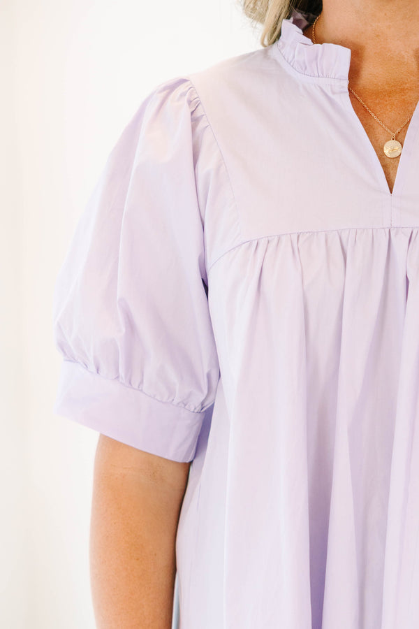 Plus Size lavender babydoll top with puff sleeves, a ruffled split neckline, and pleated bodice.