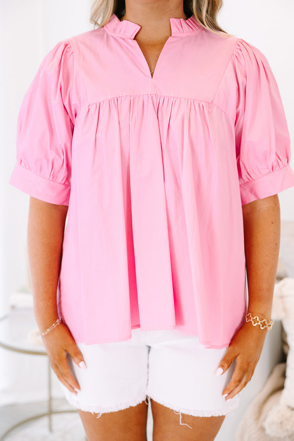 Plus Size pink babydoll top with puff sleeves, a ruffled v-neckline, and a flowy fit.