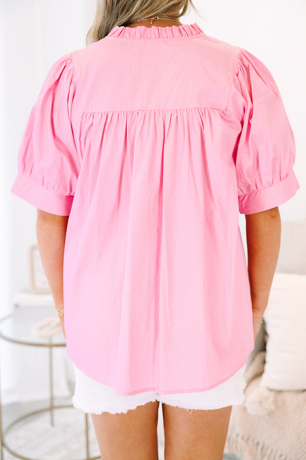 Plus Size pink babydoll top with puff sleeves, a ruffled v-neckline, and a flowy fit.