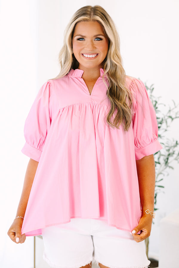 Plus Size pink babydoll top with puff sleeves, a ruffled v-neckline, and a flowy fit.