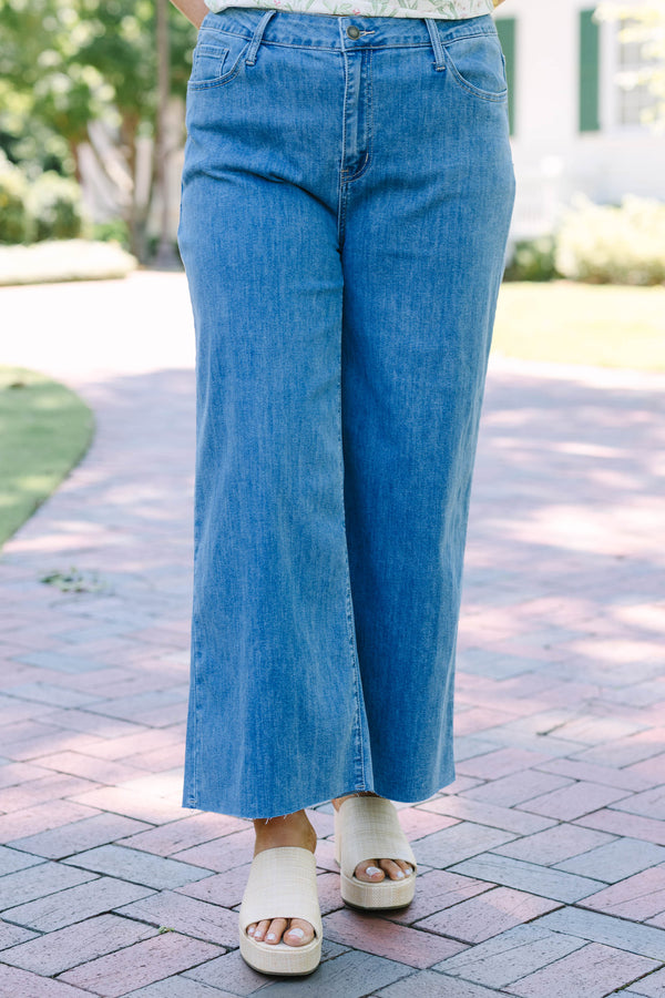 Plus Size light wash wide leg jeans with a raw hem and classic five-pocket styling.