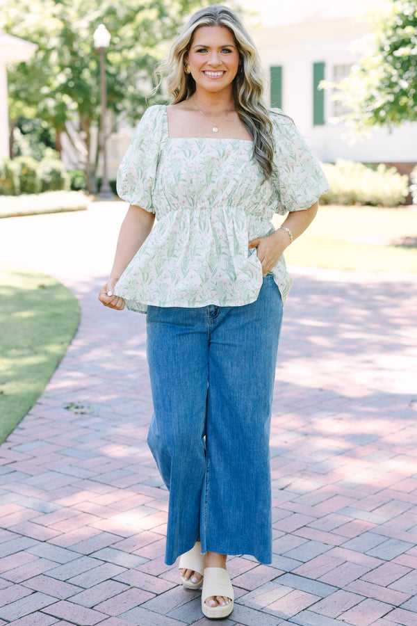 Plus Size light wash wide leg jeans with a raw hem and classic five-pocket styling.