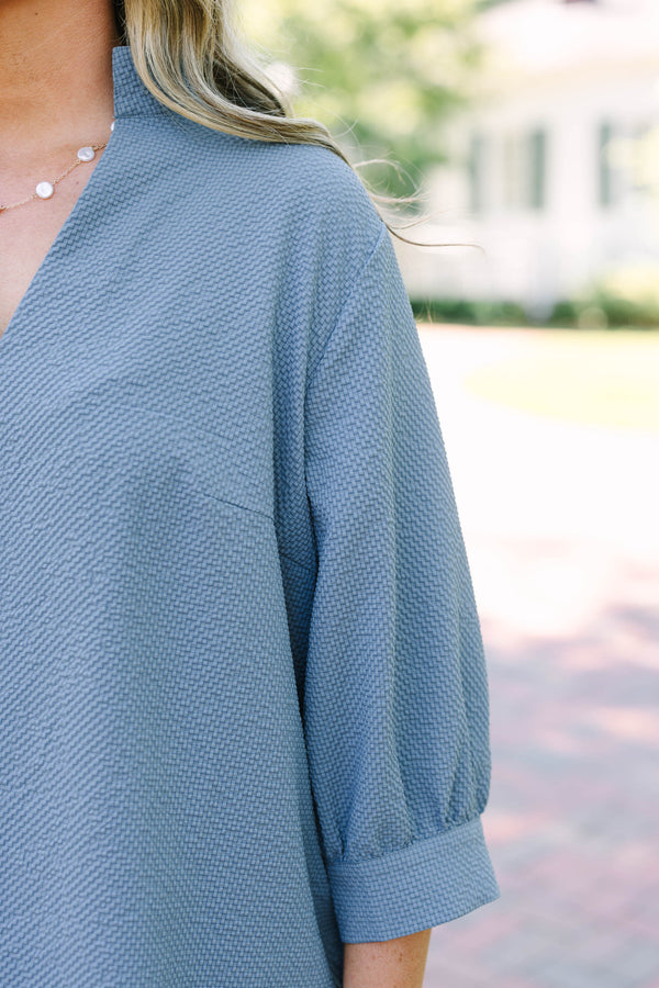 Plus Size steel blue textured top with a V-neckline and three-quarter length puff sleeves.