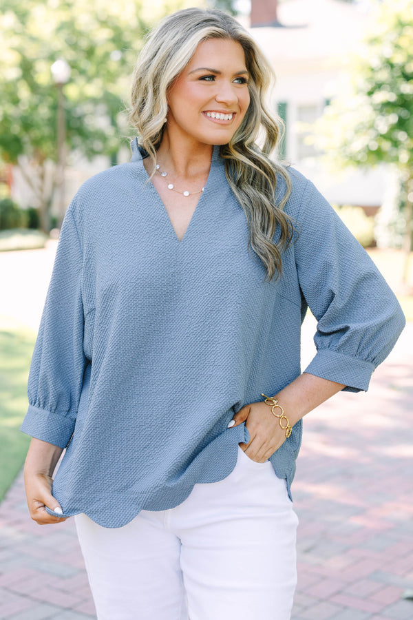 Plus Size steel blue textured top with a V-neckline and three-quarter length puff sleeves.