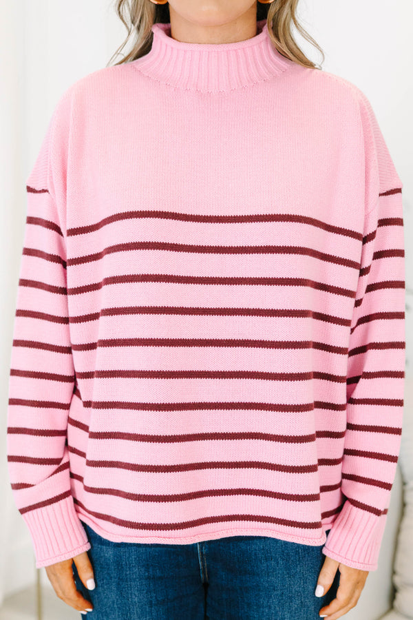 Plus size pink rollneck sweater with burgundy horizontal stripes and a relaxed, flowy fit.
