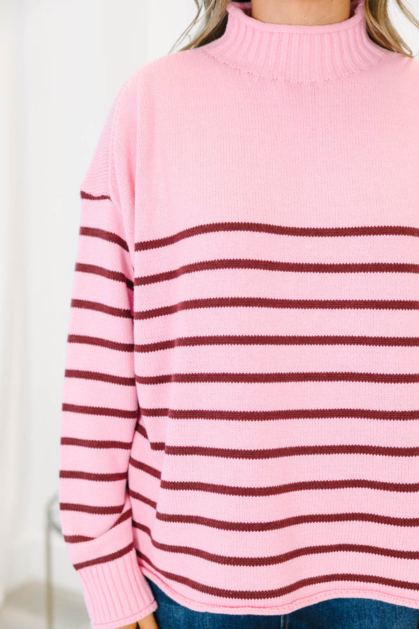 Plus size pink rollneck sweater with burgundy horizontal stripes and a relaxed, flowy fit.