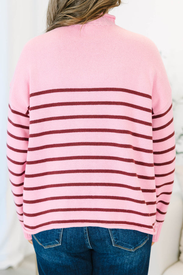 Plus size pink rollneck sweater with burgundy horizontal stripes and a relaxed, flowy fit.