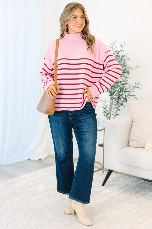 Plus size pink rollneck sweater with burgundy horizontal stripes and a relaxed, flowy fit.