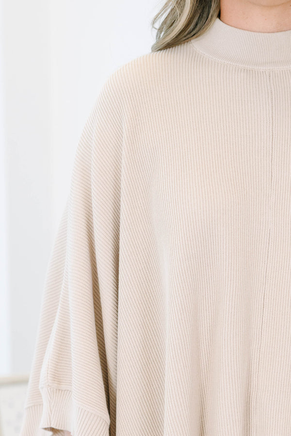 Plus Size taupe ribbed knit poncho with a mock neckline and wide, draped sleeves.