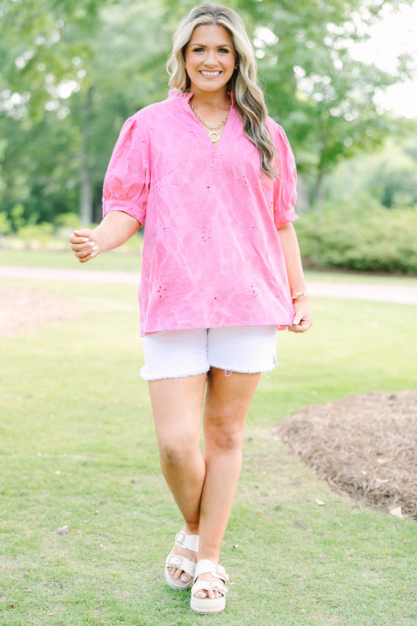Plus Size pink eyelet top with puff sleeves, a split neckline, and white denim shorts.