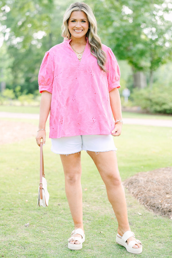 Plus Size pink eyelet top with puff sleeves, a split neckline, and white denim shorts.