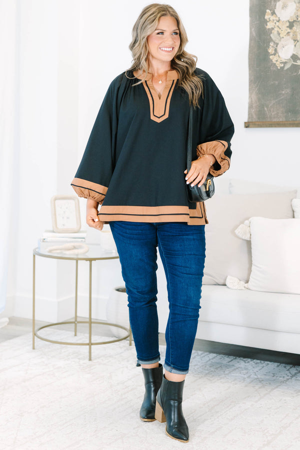 Plus Size black tunic top with tan trim, V-neckline, and long balloon sleeves.
