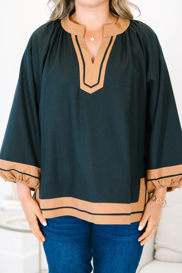 Plus Size black tunic top with tan trim, V-neckline, and long balloon sleeves.