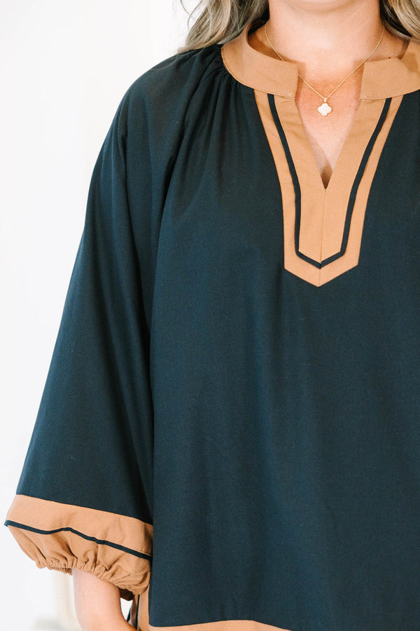 Plus Size black tunic top with tan trim, V-neckline, and long balloon sleeves.