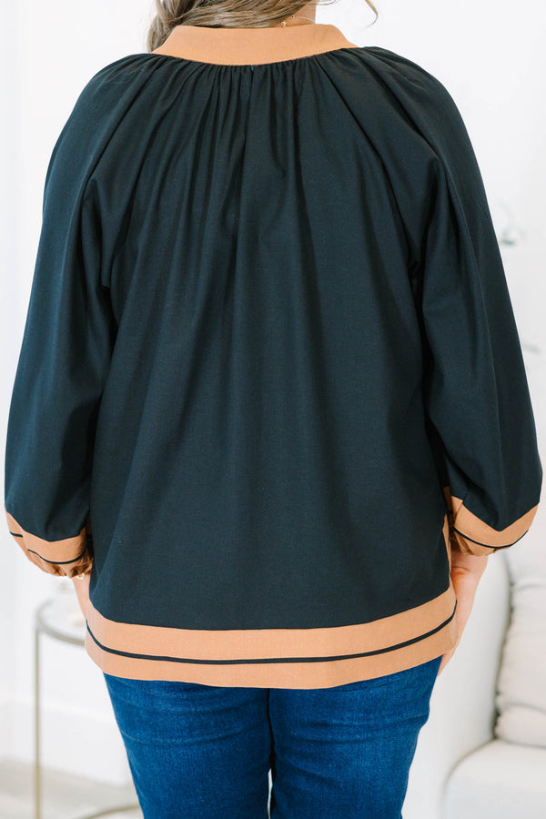 Plus Size black tunic top with tan trim, V-neckline, and long balloon sleeves.