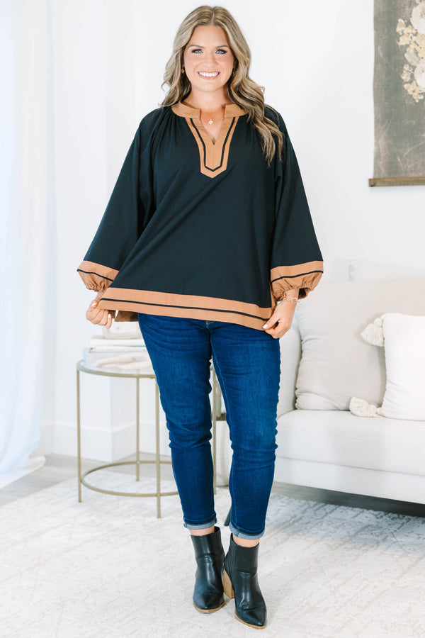 Plus Size black tunic top with tan trim, V-neckline, and long balloon sleeves.