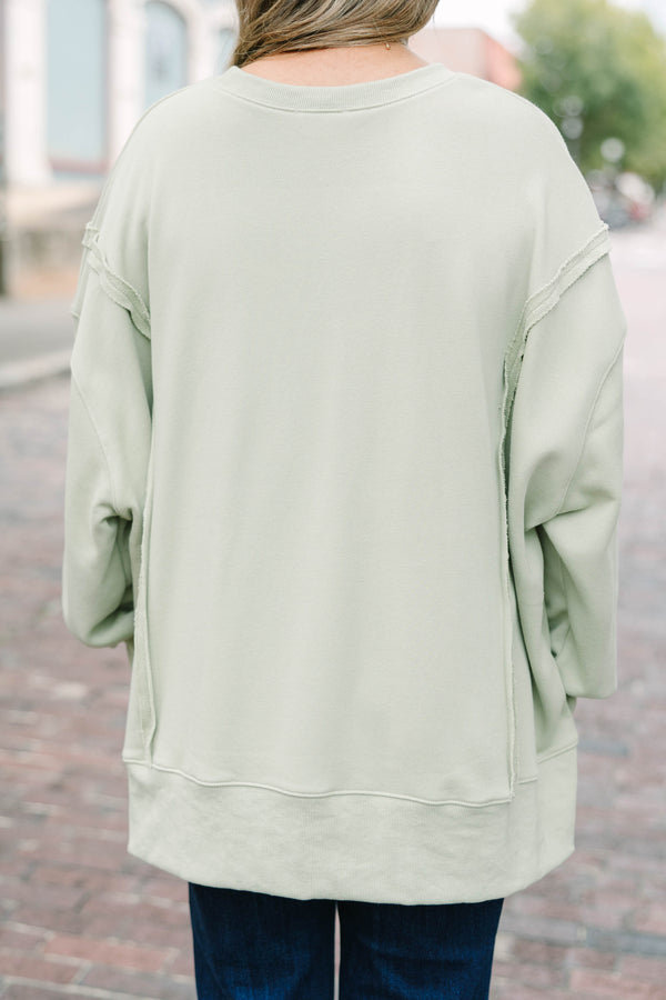 Plus Size light sage crew neck sweatshirt with a white polka dot 'FALL' graphic and raw seam detail.