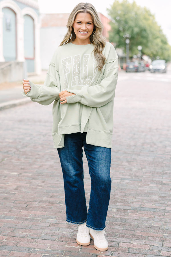 Plus Size light sage crew neck sweatshirt with a white polka dot 'FALL' graphic and raw seam detail.