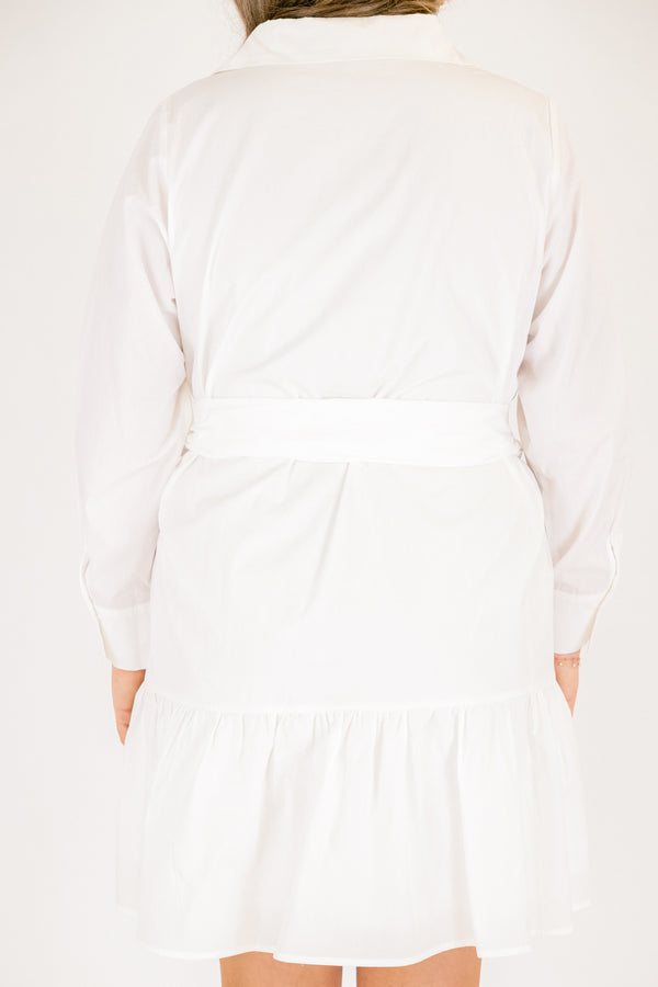 Chic Soul plus size clothing,  white dress with long sleeves a ruffle detail on the bottom of the dress buttons going down to the bottom of the chest and a belt that ties into a bow going around the waist 