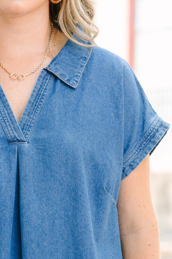 Plus Size blue denim midi dress with a collared V-neckline, short sleeves, and a frayed hem.