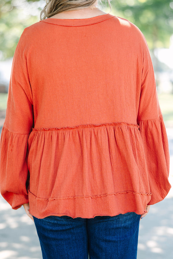 Plus Size rust-colored babydoll top with long puff sleeves, a button-down front, and textured fabric.