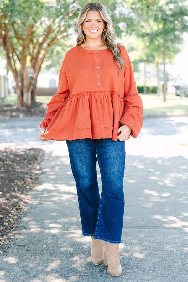 Plus Size rust-colored babydoll top with long puff sleeves, a button-down front, and textured fabric.