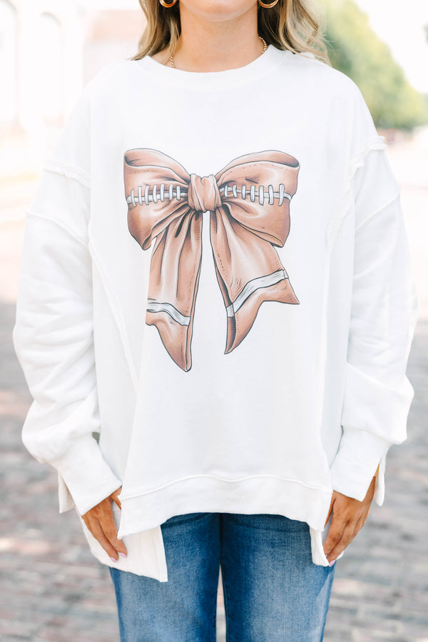 Plus Size ivory crew neck sweatshirt with a football-themed bow graphic and relaxed fit.