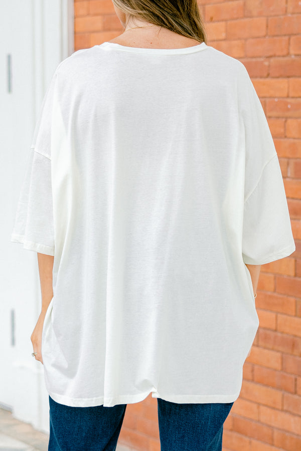 Chic Soul Plus size Clothing, Ivory Short Sleeve tee with a black smiley face on the center of the shirt that is filled with an orange floral design 
