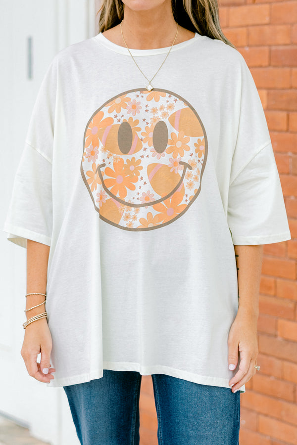 Chic Soul Plus size Clothing, Ivory Short Sleeve tee with a black smiley face on the center of the shirt that is filled with an orange floral design 
