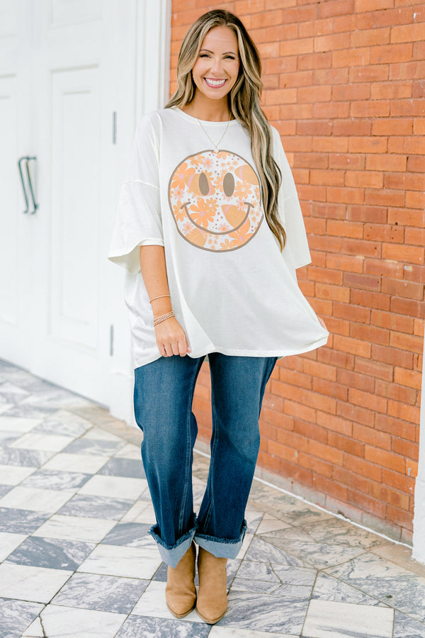 Chic Soul Plus size Clothing, Ivory Short Sleeve tee with a black smiley face on the center of the shirt that is filled with an orange floral design 
