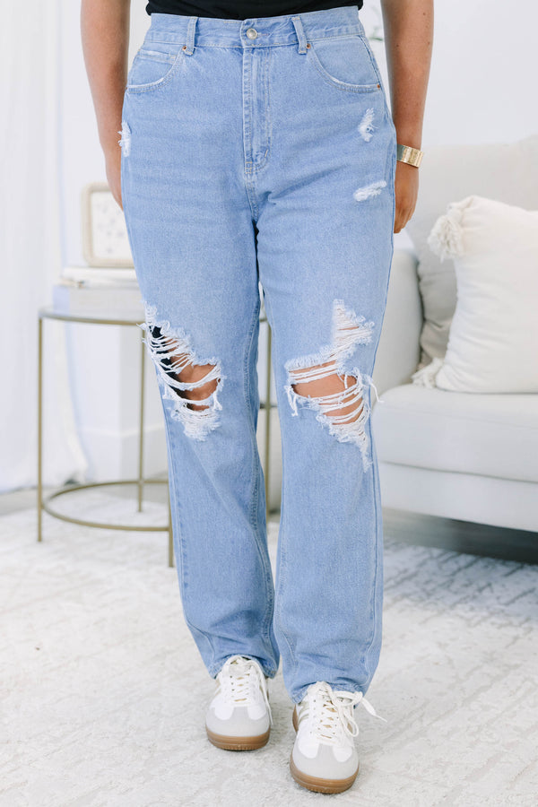 Plus Size light wash straight leg jeans with heavy distressing and ripped knees.