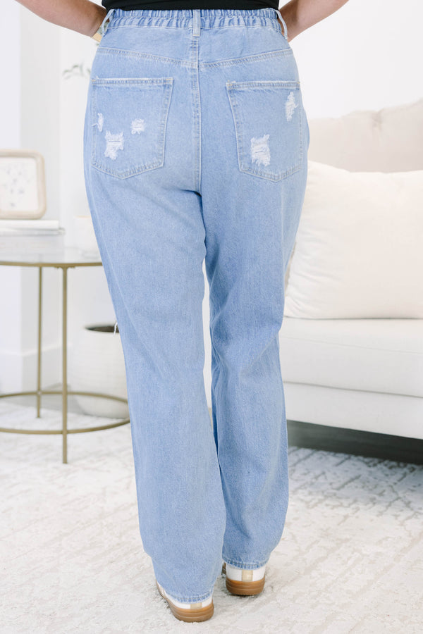Plus Size light wash straight leg jeans with heavy distressing and ripped knees.
